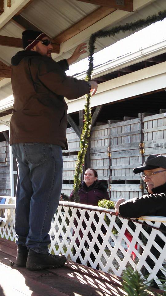 MIke Walsh, Erin Hensh and Paul Cavaliere decorate the float.