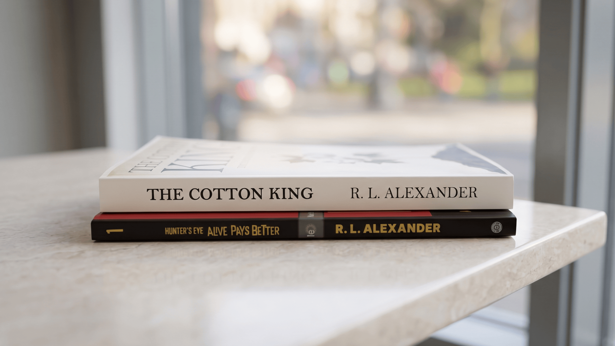 Two R. L. Alexander Novels on a white table. 
