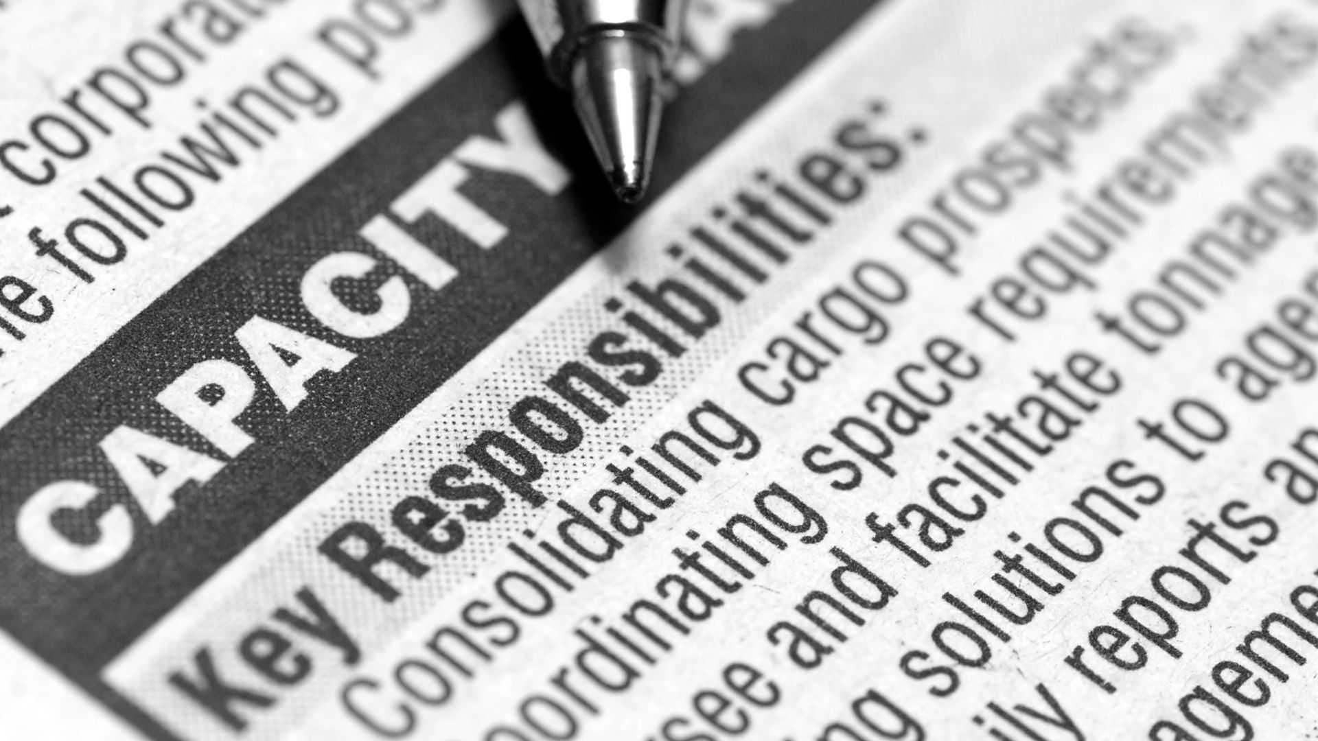 Close-up of a newspaper-style job advertisement, symbolizing the importance of writing targeted and detailed job ads.