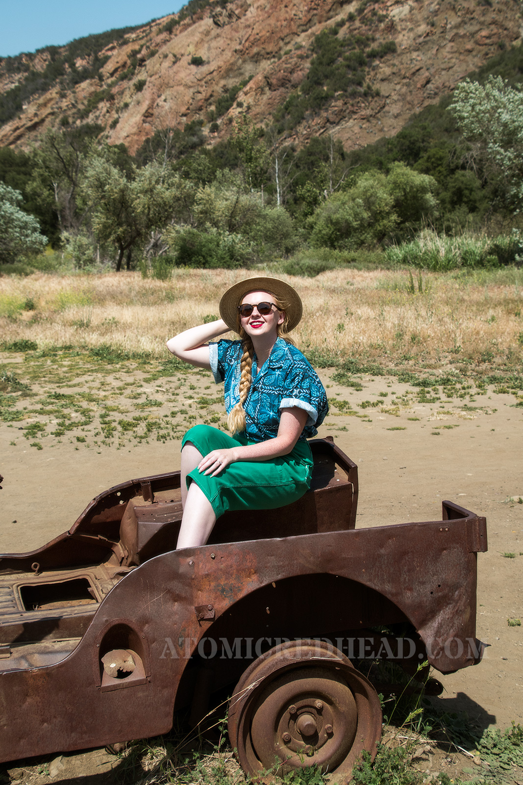 Sitting in a rusted out old jeep once used in the show.