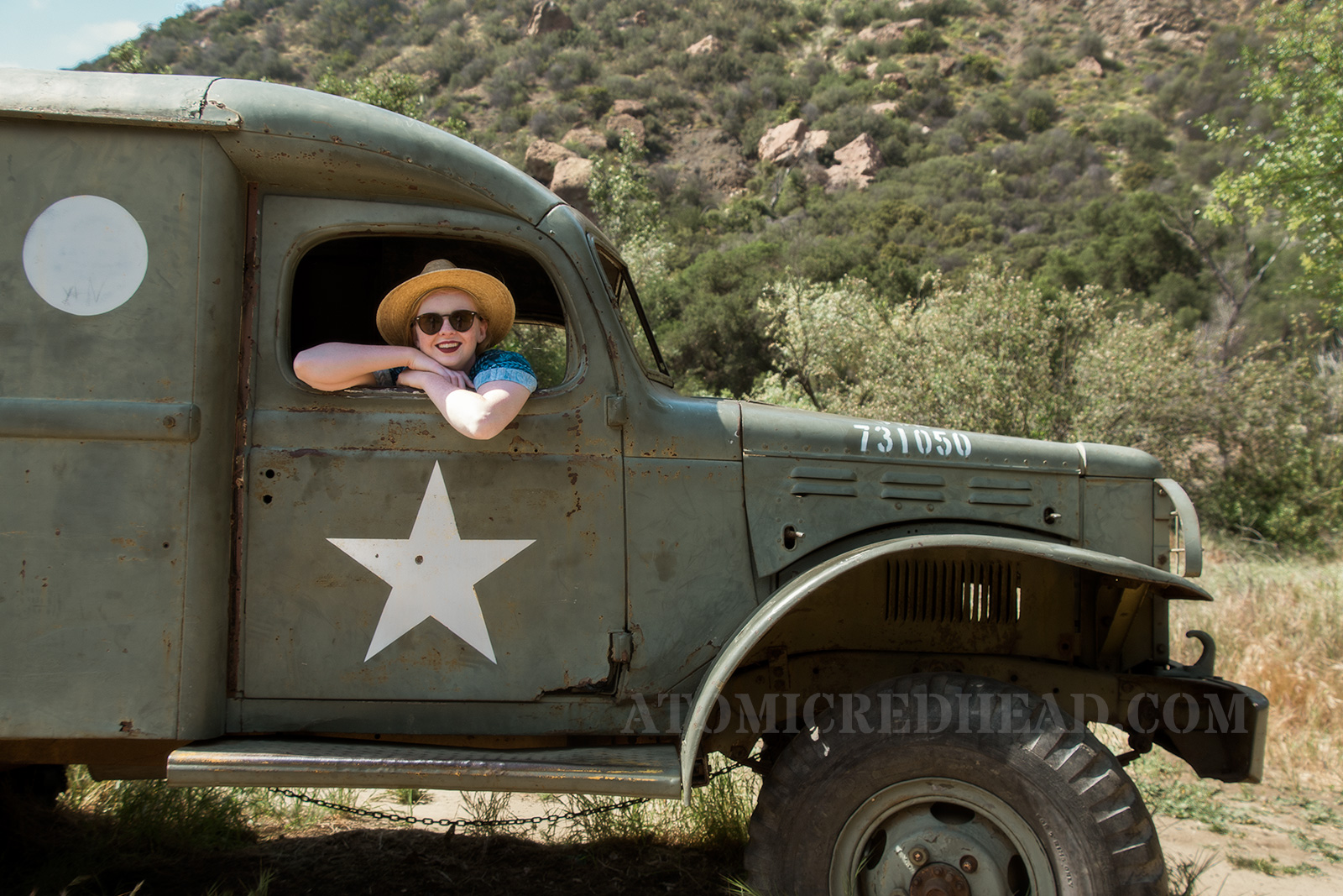 Sitting inside of the ambulance with my head and arms outside the window.