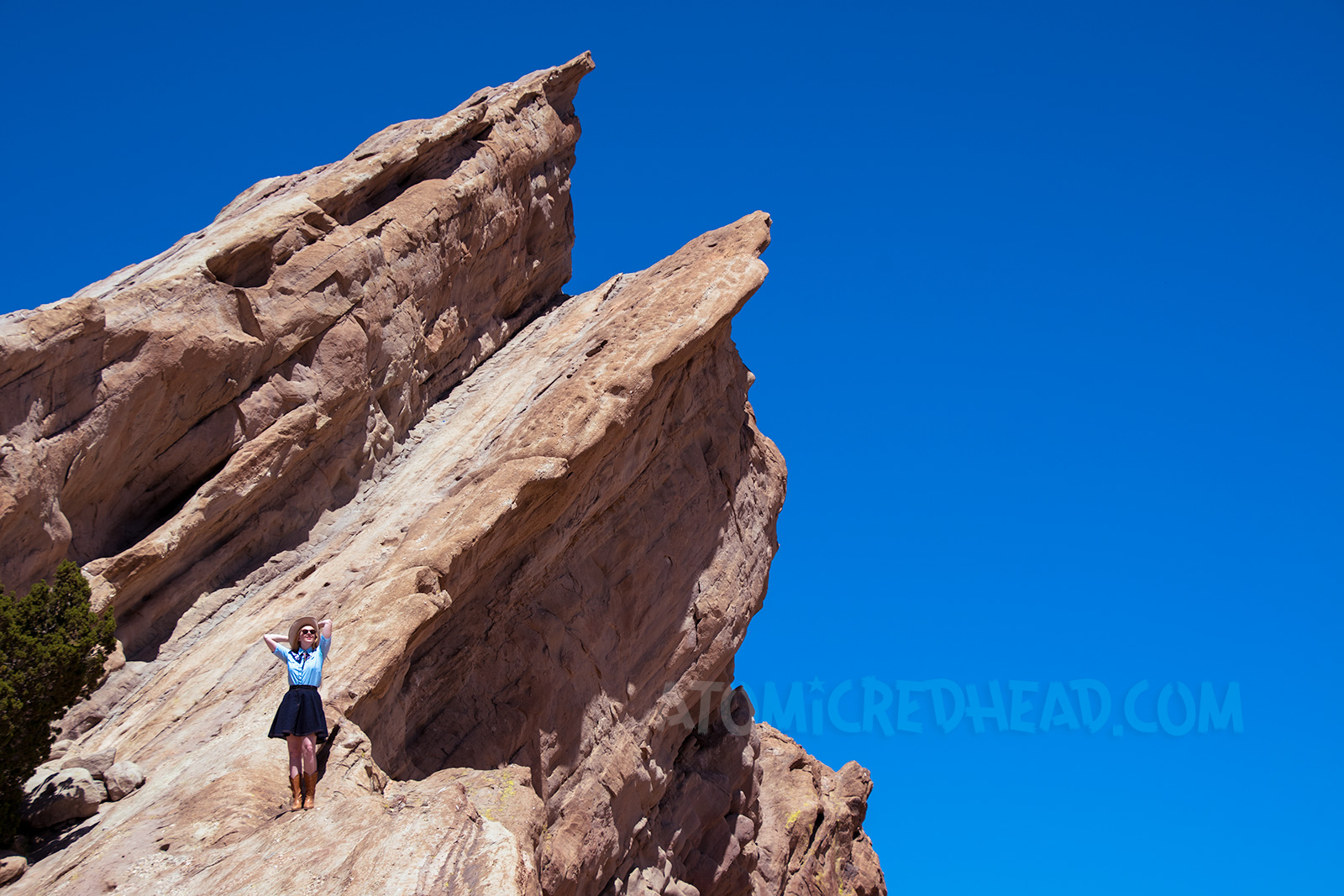 Atop Vasquez Rocks in a denim skirt, two-tone western shirt, UFO bolo tie by Kesha, and a cream western wear hat.