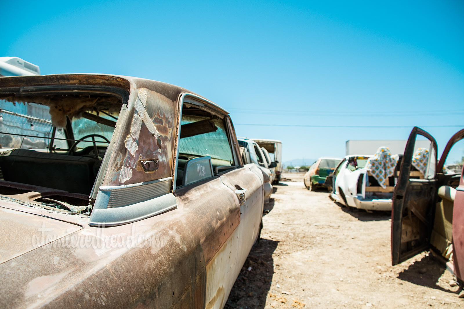 Art Installation - The Bombay Beach Drive-In, a faux drive-in with old, junk cars and a large trailer painted white to emulate a screen.