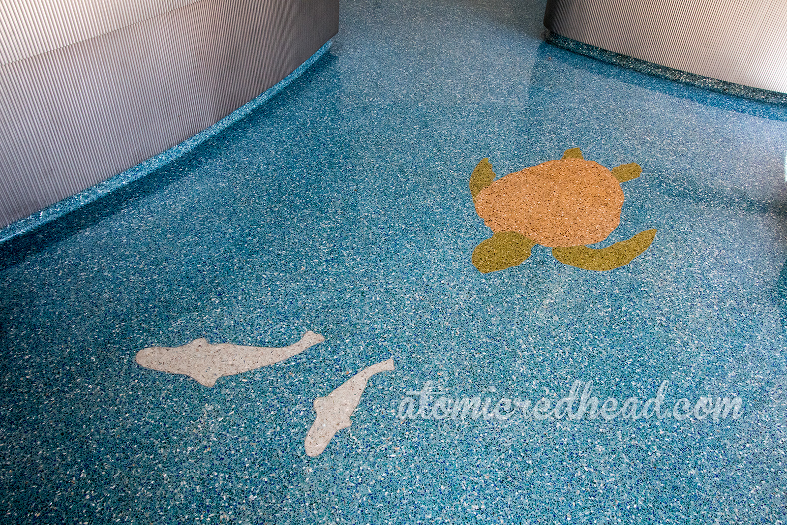 Mosaic florors featuring a turtle and fish, inside the lobby of the HoJo