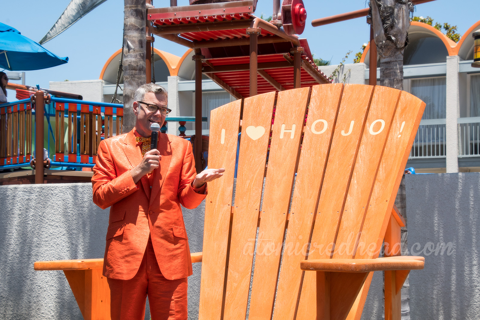 Charles Phoenix, in his orange suit, speaks about the history of HoJo.