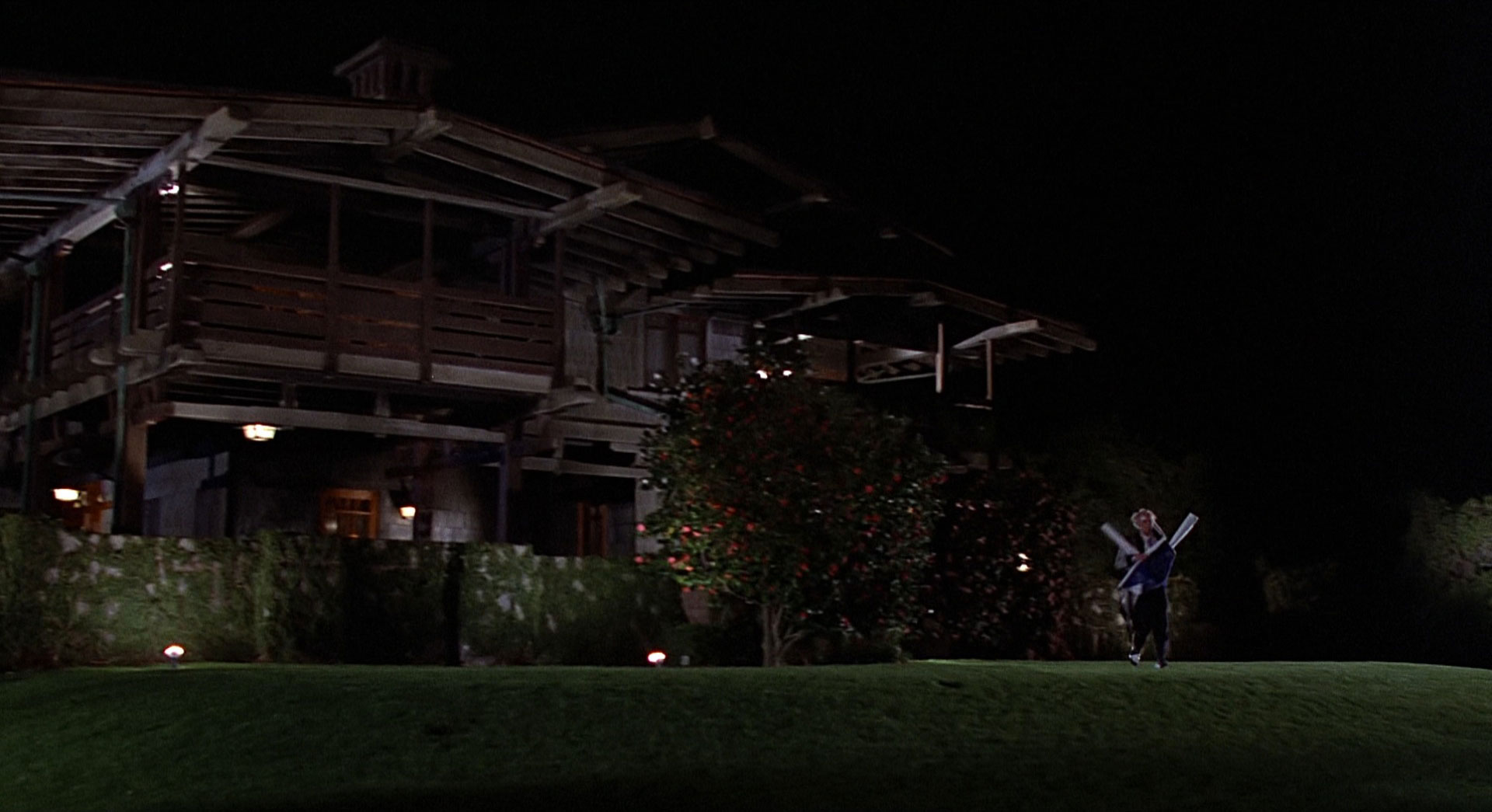 Screencap from Back to the Future - Doc Brown tries to escape Marty by running out from the house.