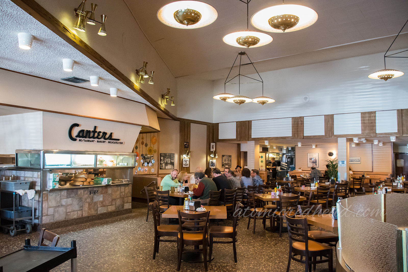 Interior of Canter's - Vintage UFO style gold light fixtures hang from the ceiling.