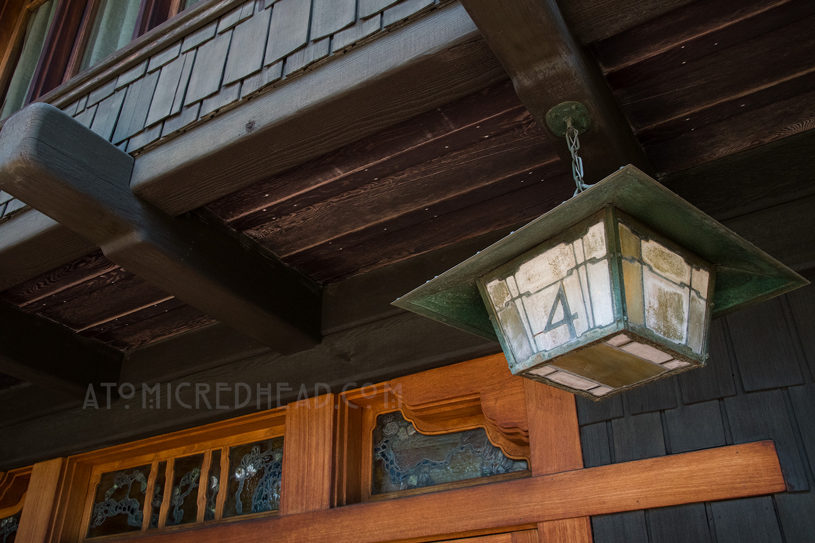 Close-up of the house number, which is metal over stained glass.