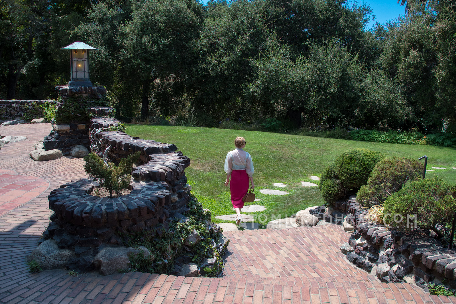 Walking away from the Gamble House on their trail of stones through the gress.