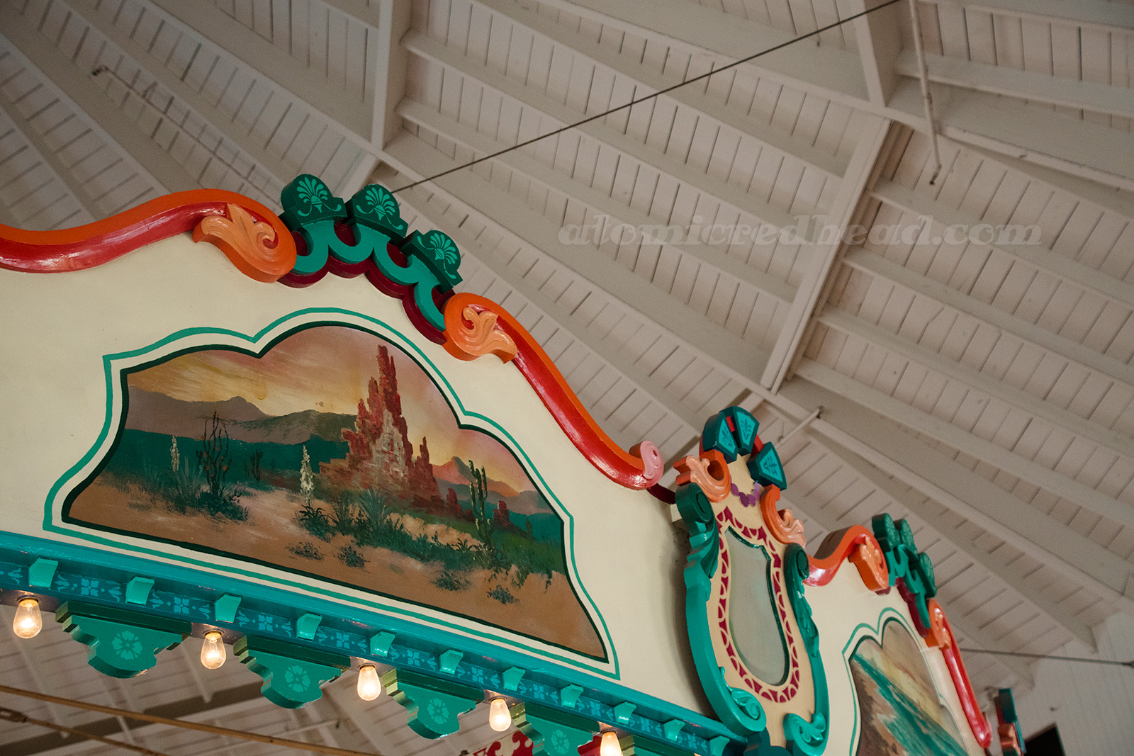 Along the top various murals of nature, including a large desert rock formation.