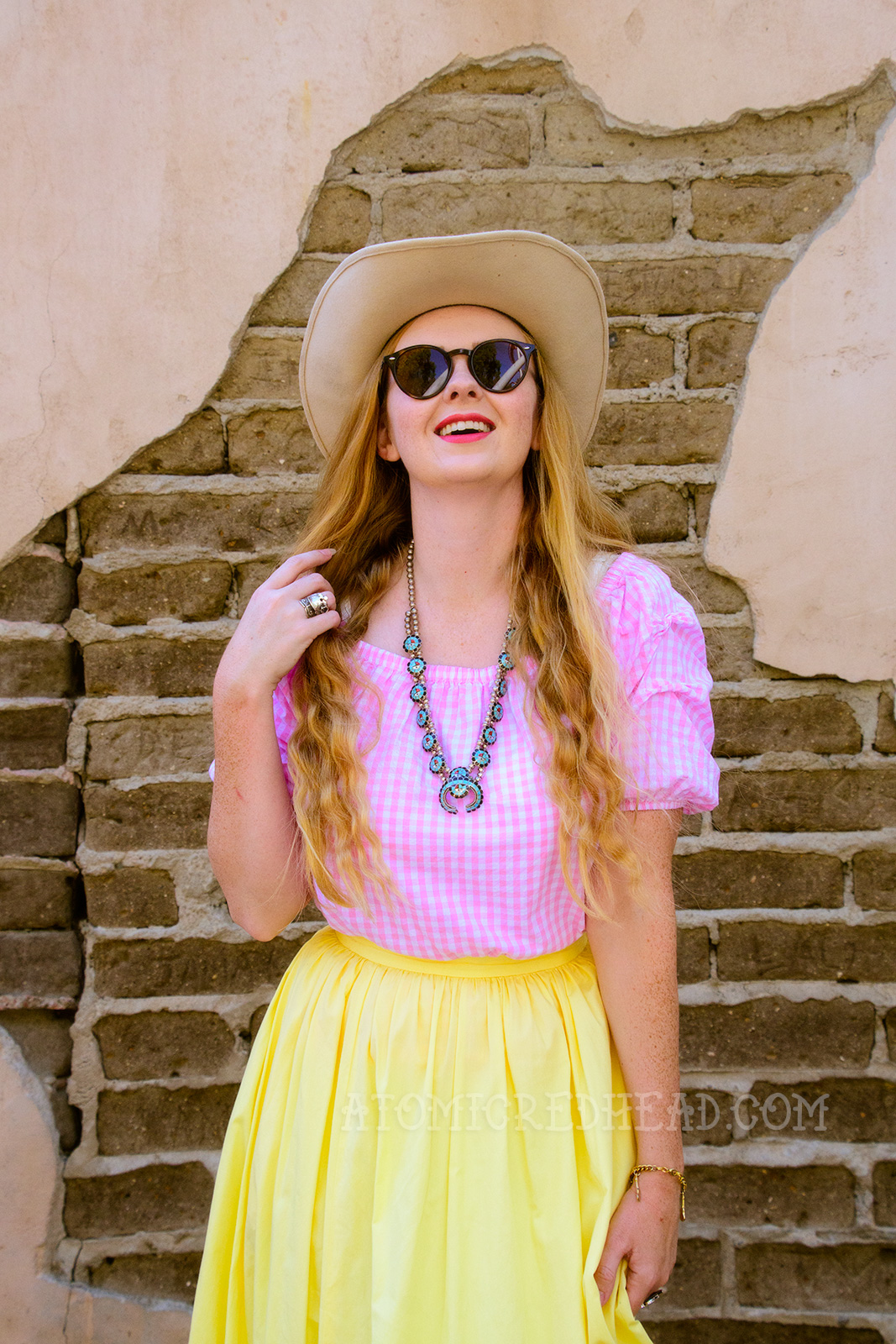 Inspired by the Sweetheart of the Rodeo, a cream cowboy hat, pink and white gingham peasant top, butter yellow skirt, and cowboy boots.