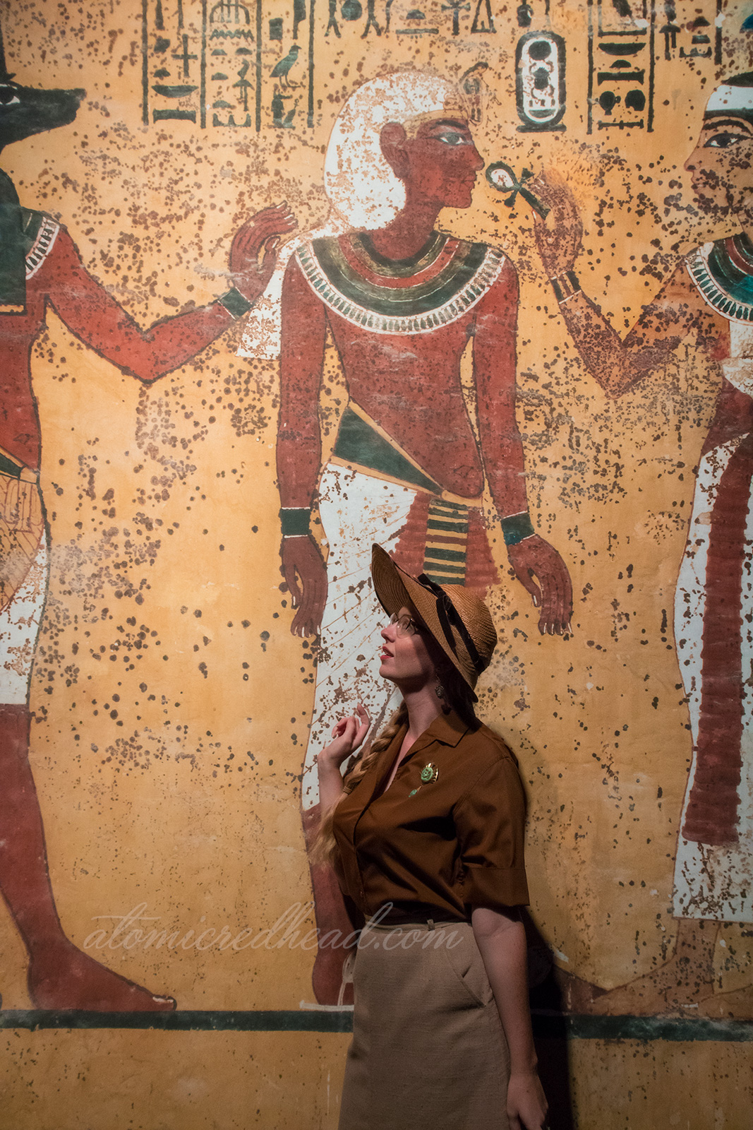Me, standing against a backdrop that looks like the walls of an Egyptian tomb.