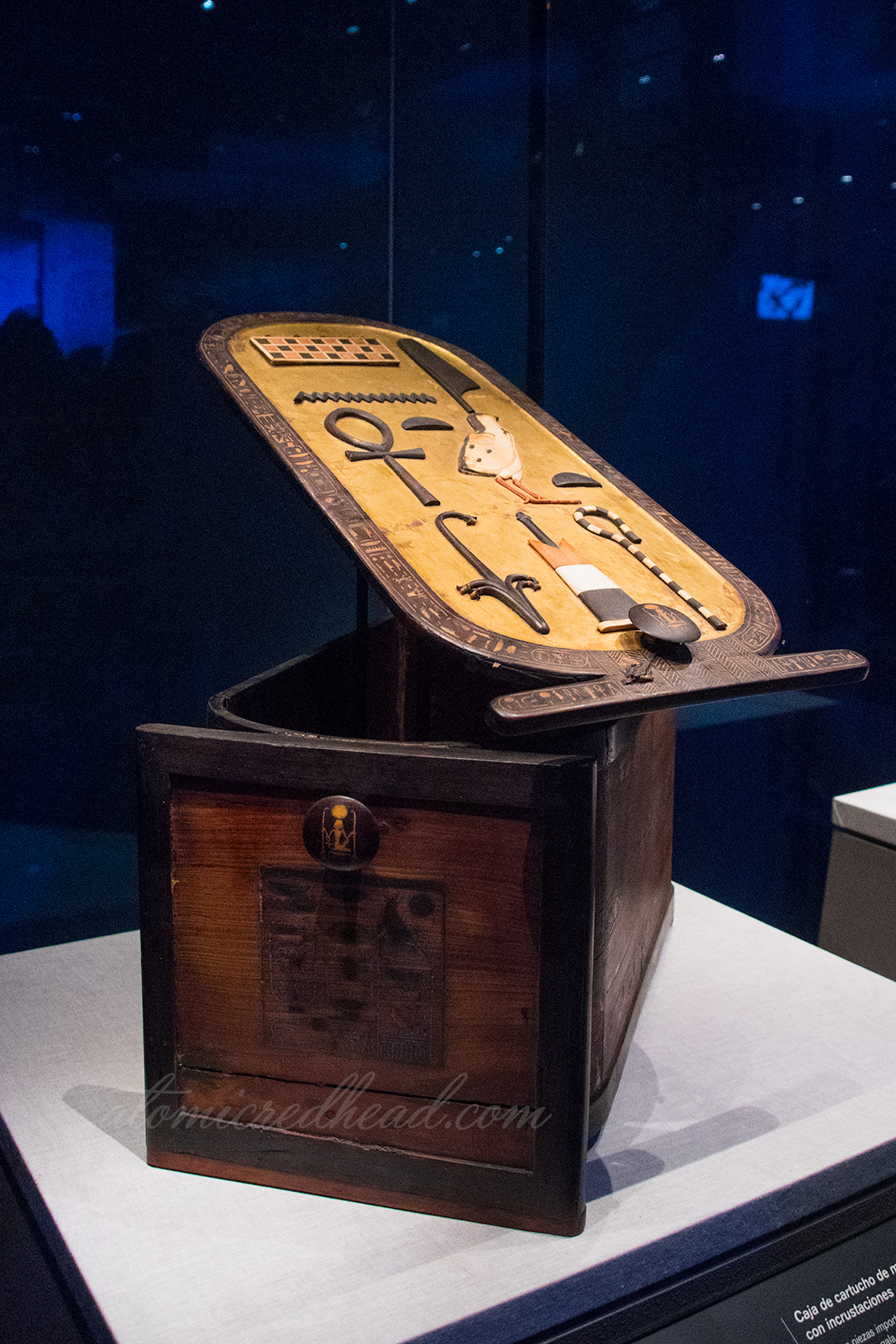 A carved box where the lid is a cartouche featuring Tut's name.