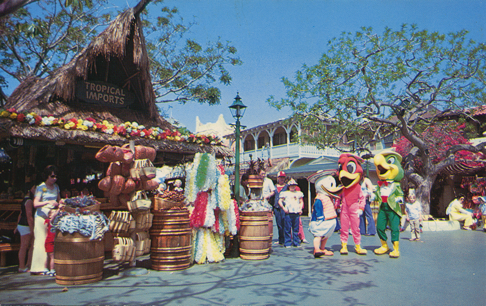 The Three Caballeros visit Tropical Imports, a tiki-esque shop in Adventureland with a high peaked thatch roof.