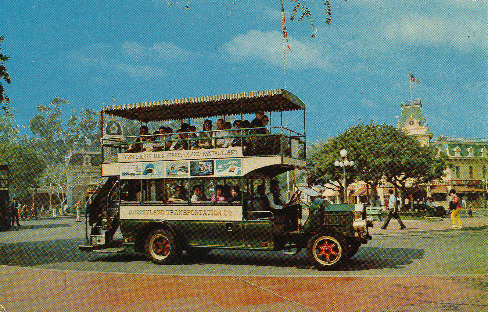 Disneyland's Omnibus, green with red wheels, takes Guests up and down Main Street.