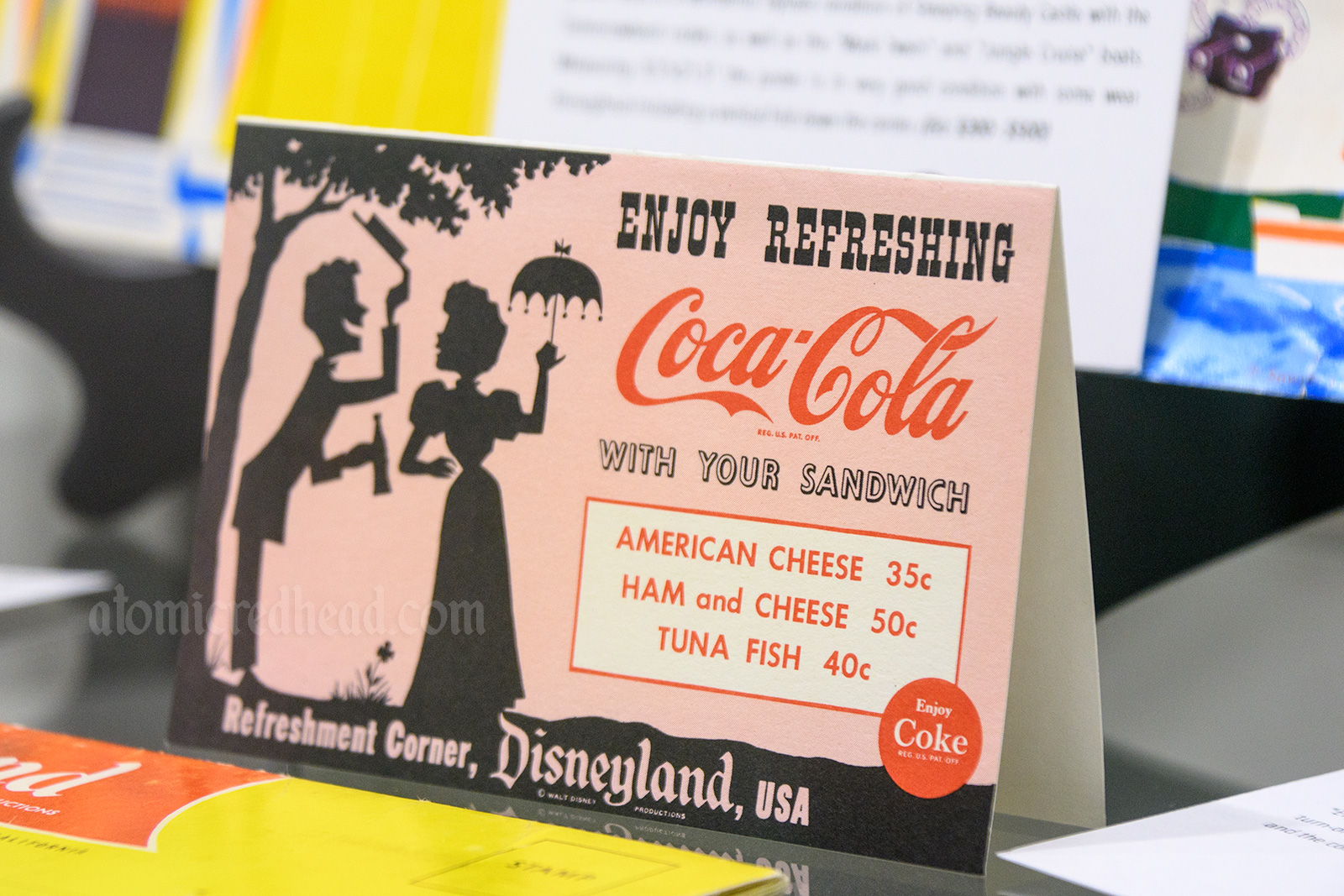 Coca-Cola Refreshment Corner menu, featuring illustration of a gay 90s couple.