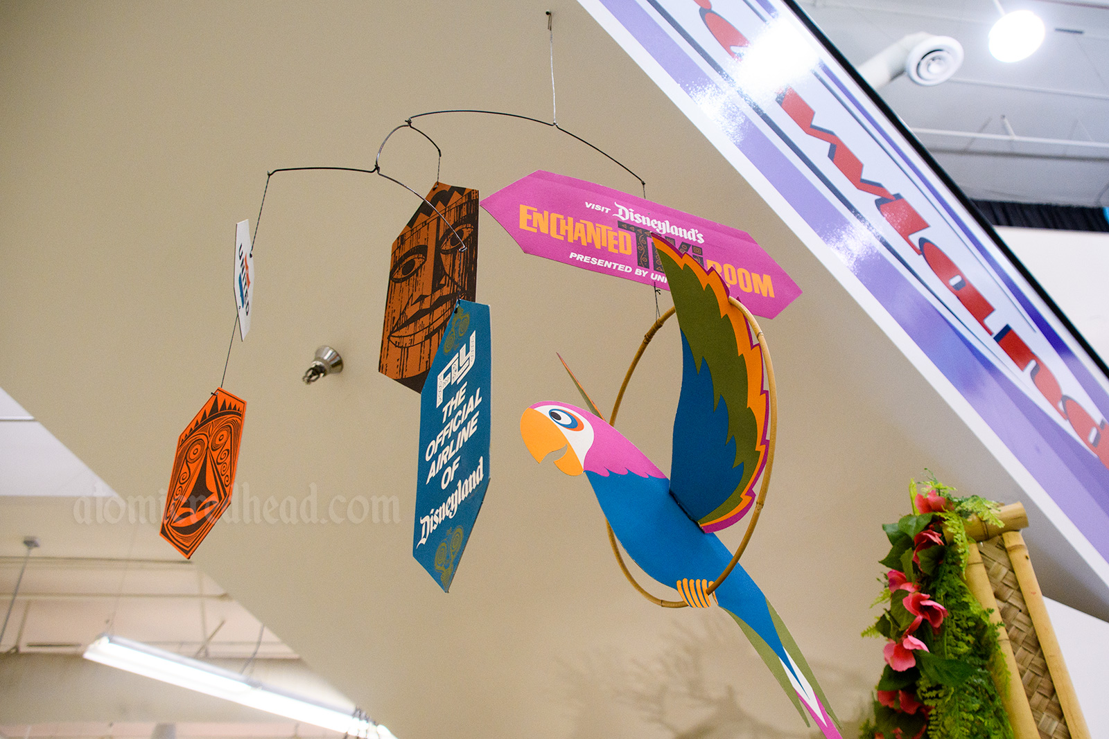 Cardboard mobile for the Enchanted Tiki Room, multi-color, reading "Fly the official airline of Disneyland"