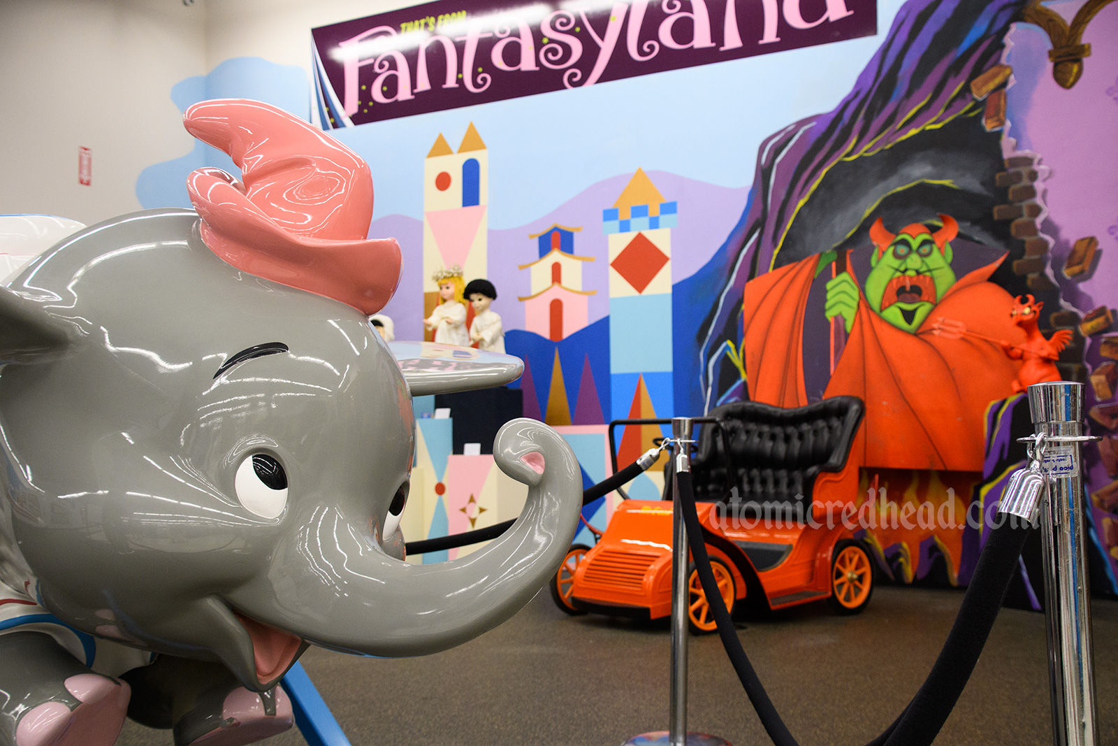 Dumbo ride vehicle, Mr. Toad's Wild Ride ride vehicle, with a devil in the background.