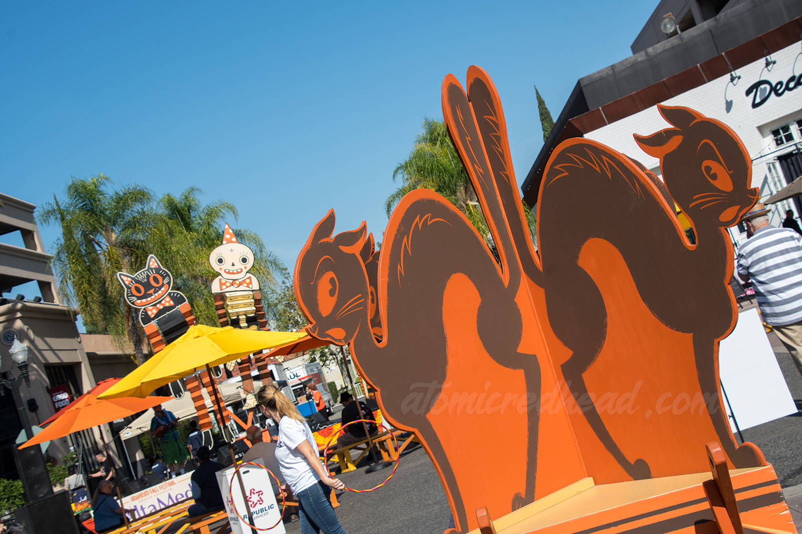 A group of black cats painted on wood.