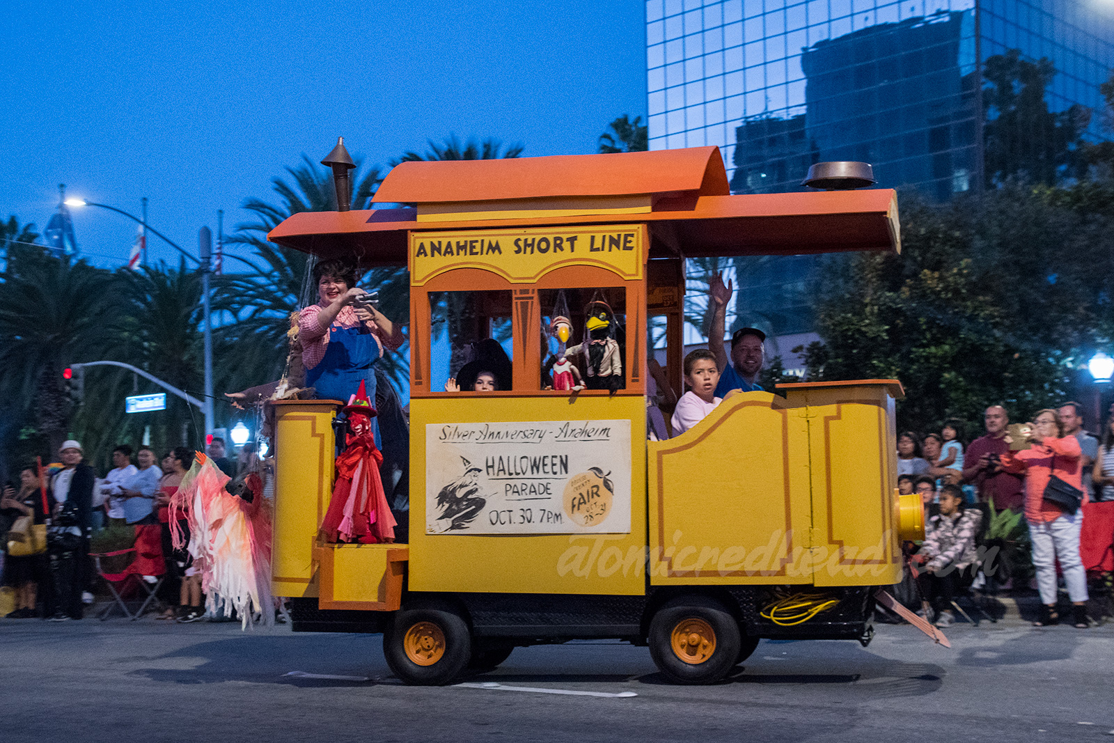 A faux old-fashioned trolley carries the Bob Baker Marionette performers with various puppets.
