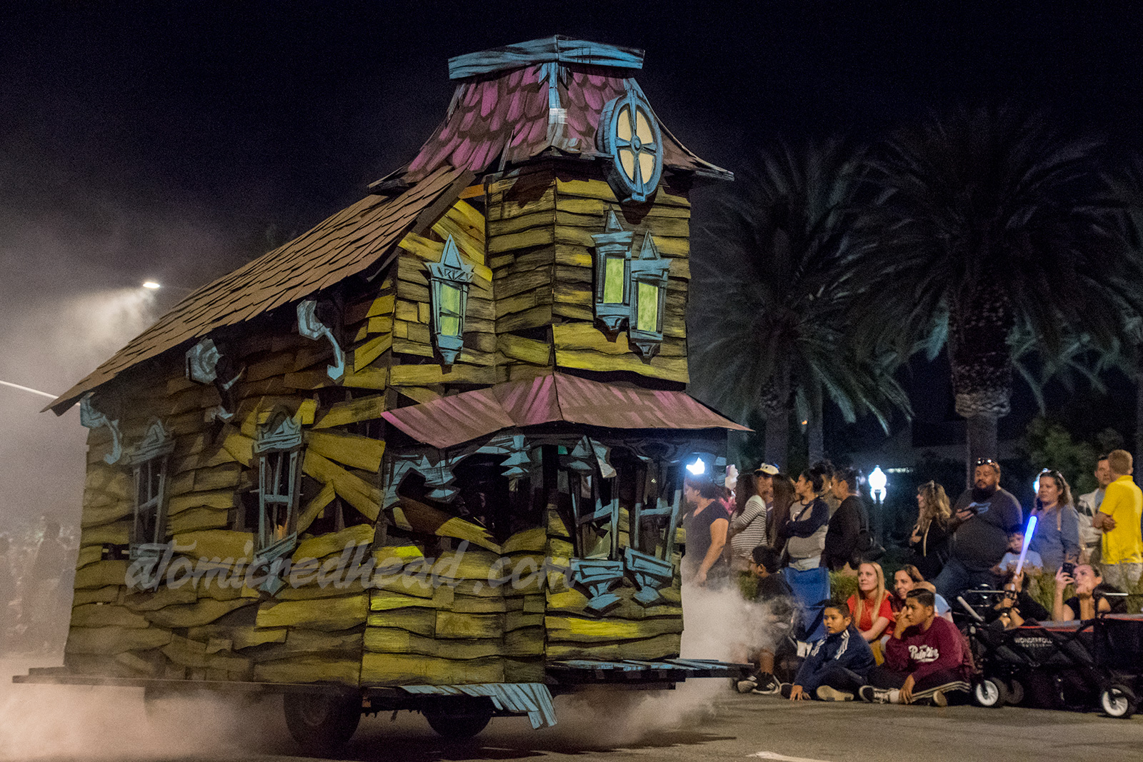 A spooky house of green sides and purple roof.