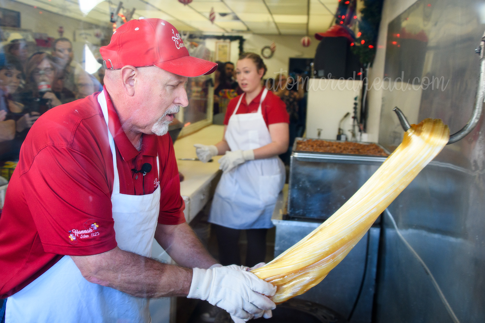 Jerry uses a large hook anchored to the wall to pull the sugar to transform it from amber to white.