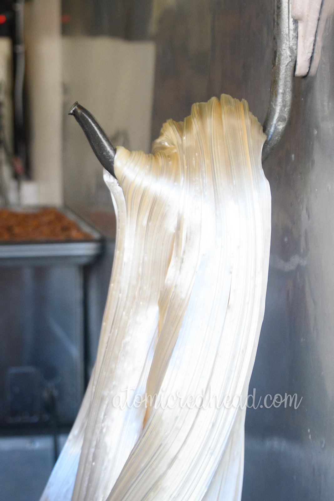 A close up of the sugar on the hook, appearing almost to look like hair.