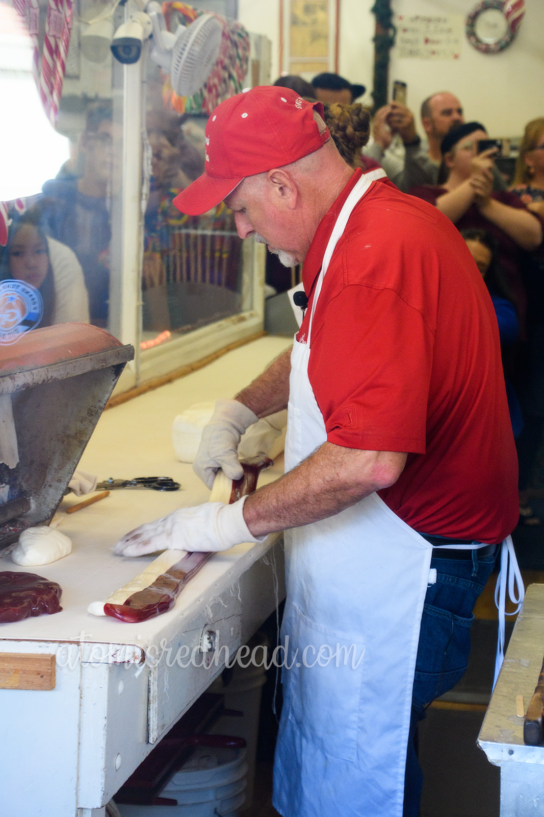 After cutting part of the sugar away and dying it red, it is cut into strips to make the stripes of the candy cane.