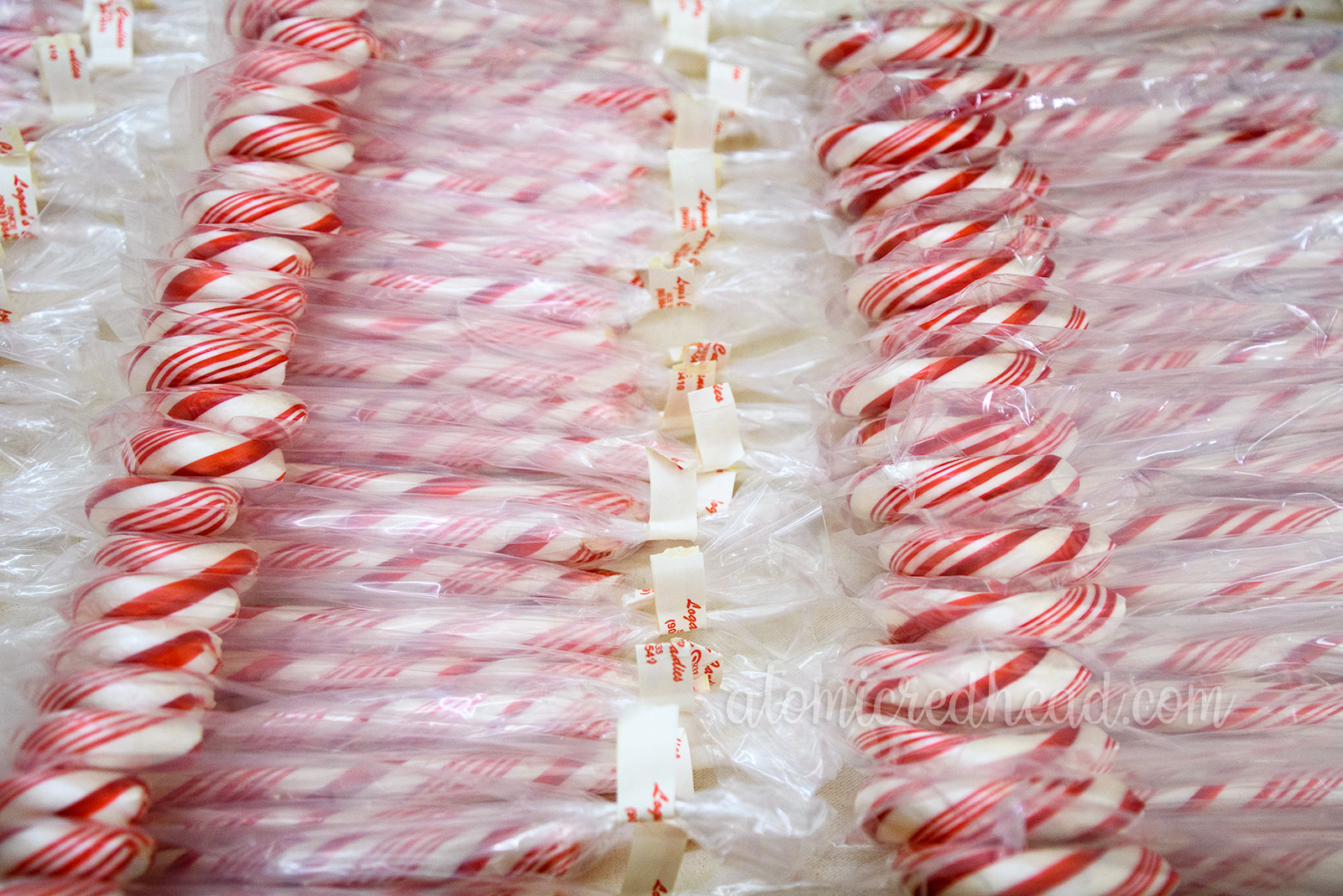 Rows upon rows of candy canes bagged up.