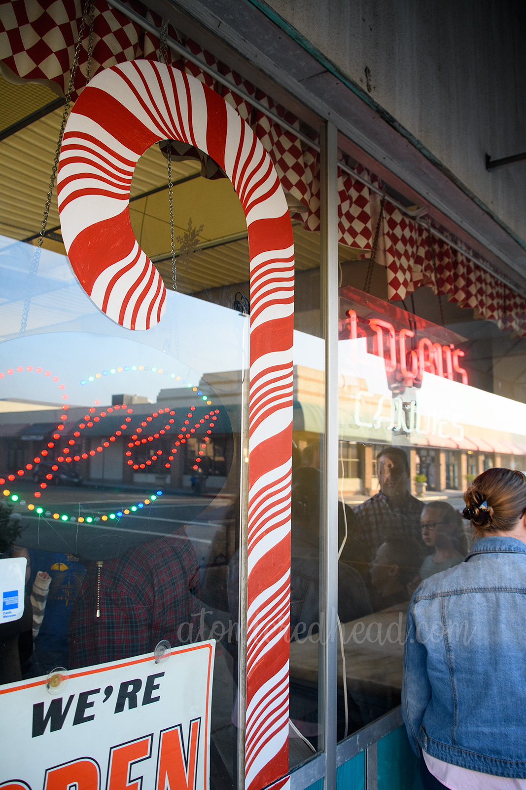 A large candy cane painted on the outside window.