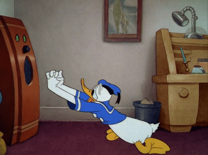 Donald sits on his knees pleading with his radio.