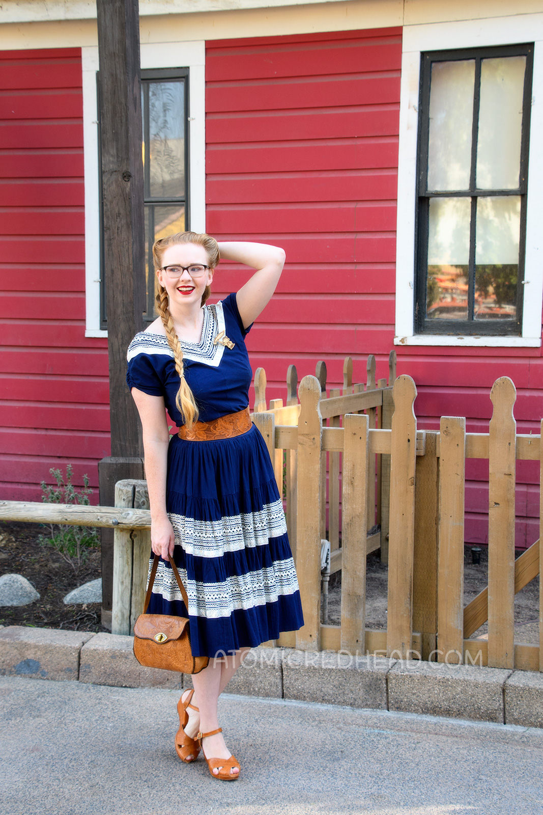 Myself wearing a navy colored patio set with silver ric-rac trim, and a tooled leather belt, purse, and shoes.