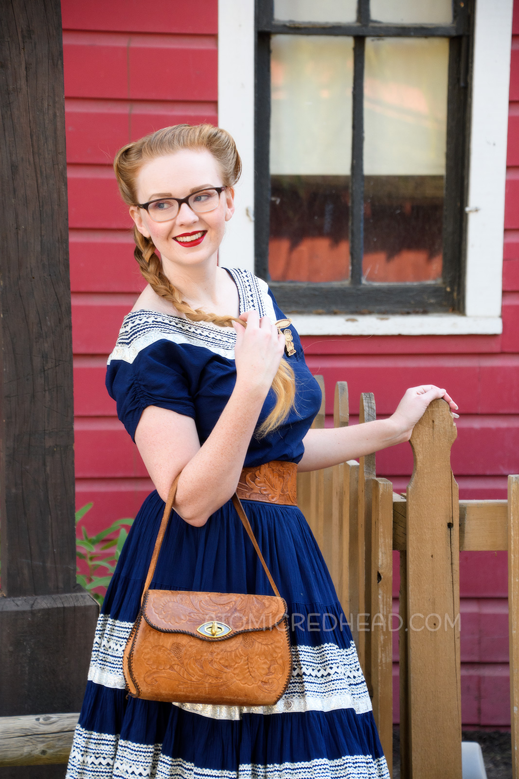 Myself wearing a navy colored patio set with silver ric-rac trim, and a tooled leather belt, purse, and shoes.