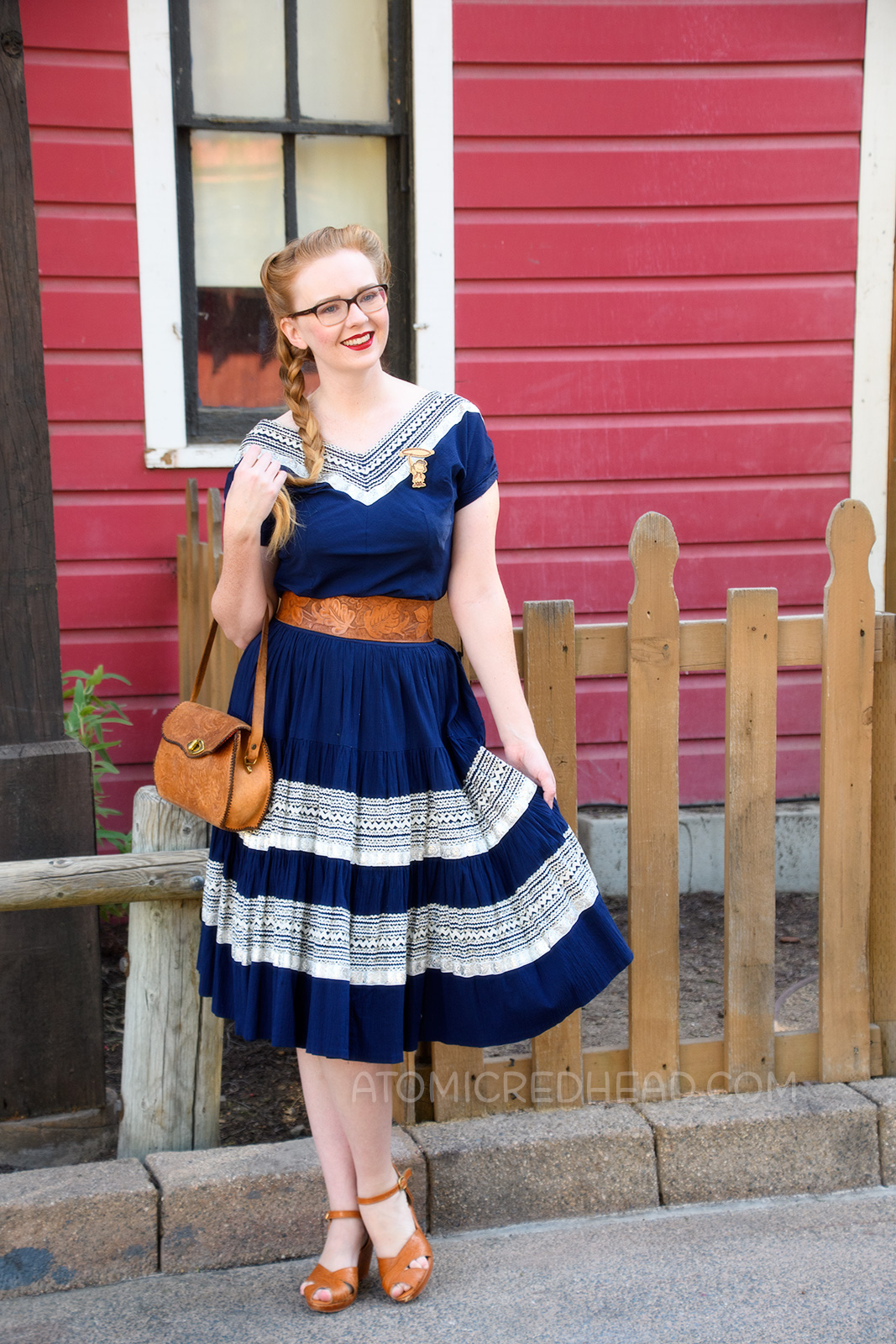 Myself wearing a navy colored patio set with silver ric-rac trim, and a tooled leather belt, purse, and shoes.