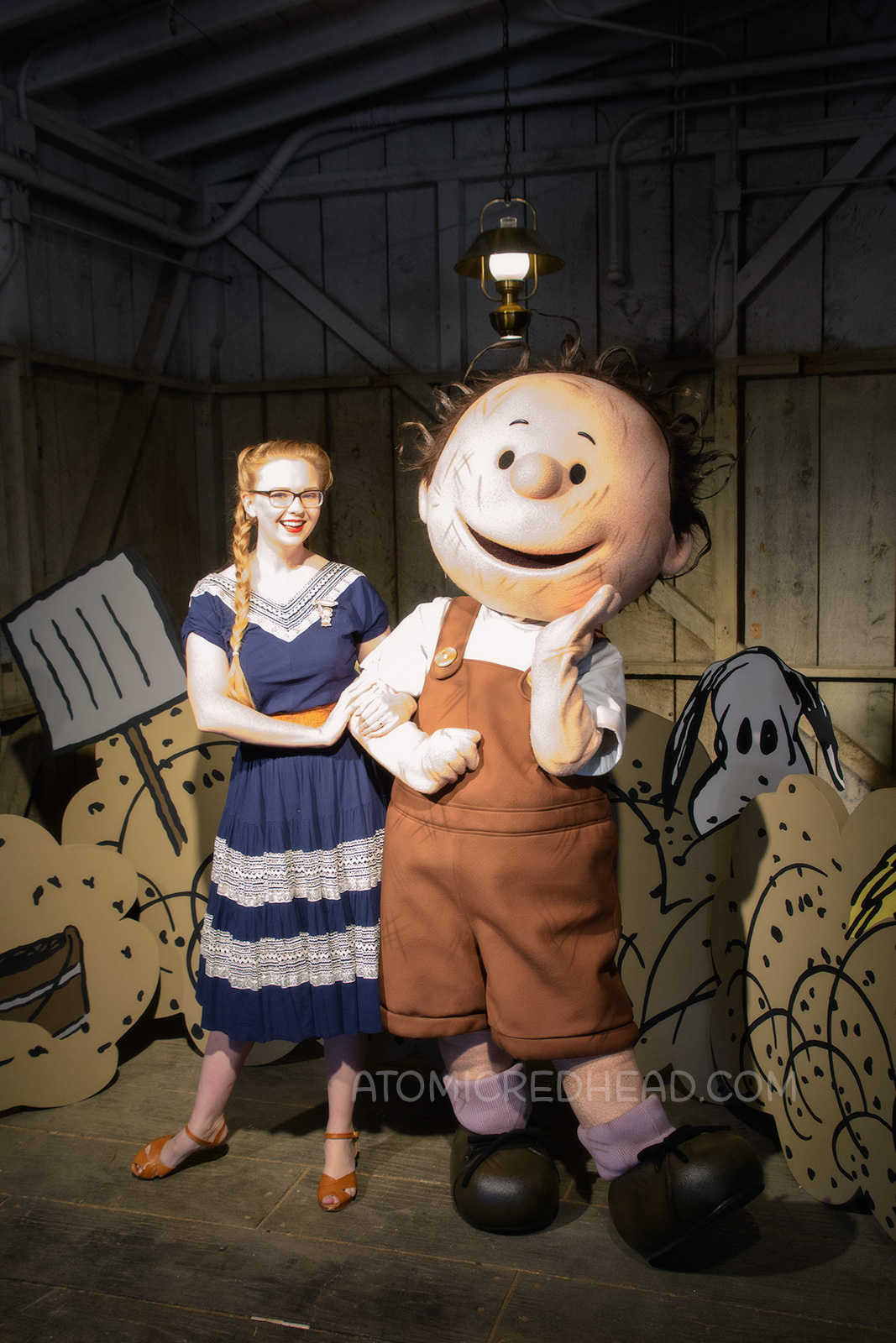 Myself, wearing a navy colored patio set with silver ric-rac trim, and a tooled leather belt, purse, and shoes, with Pig Pen.