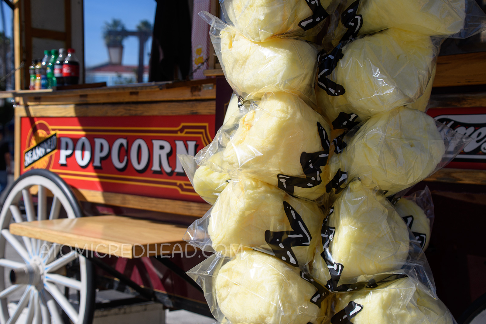 Nearby a popcorn cart, yellow cotton candy has been wrapped in a clear bag with a black zig-zag design to emulate Charle Brown's shirt.