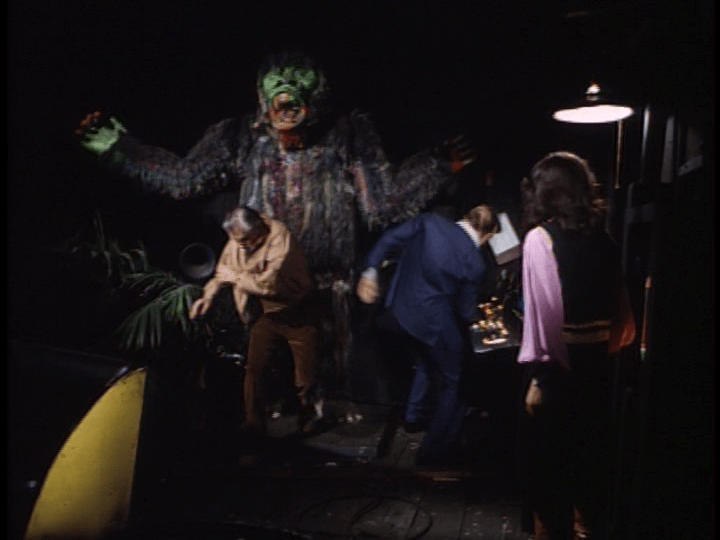 Screencap: A giant ape with a green face lords over Steve and the German spies within Laff in the Dark.