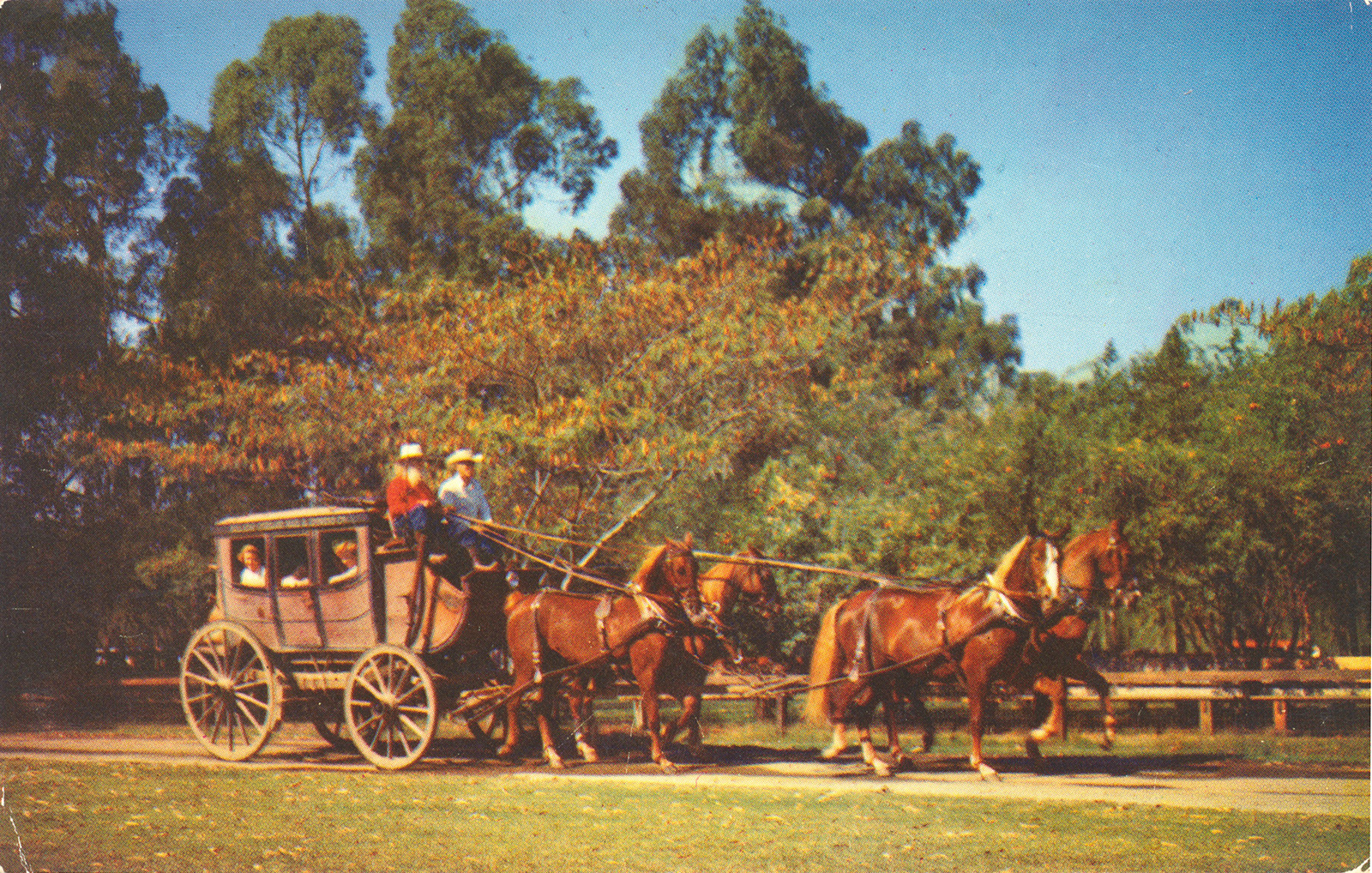 A stagecoach pulled by four brown horses.