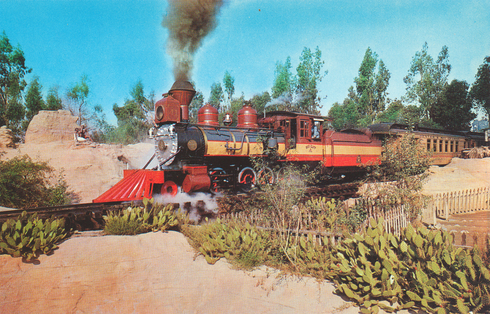 The Ghost Town train chugs past cacti.