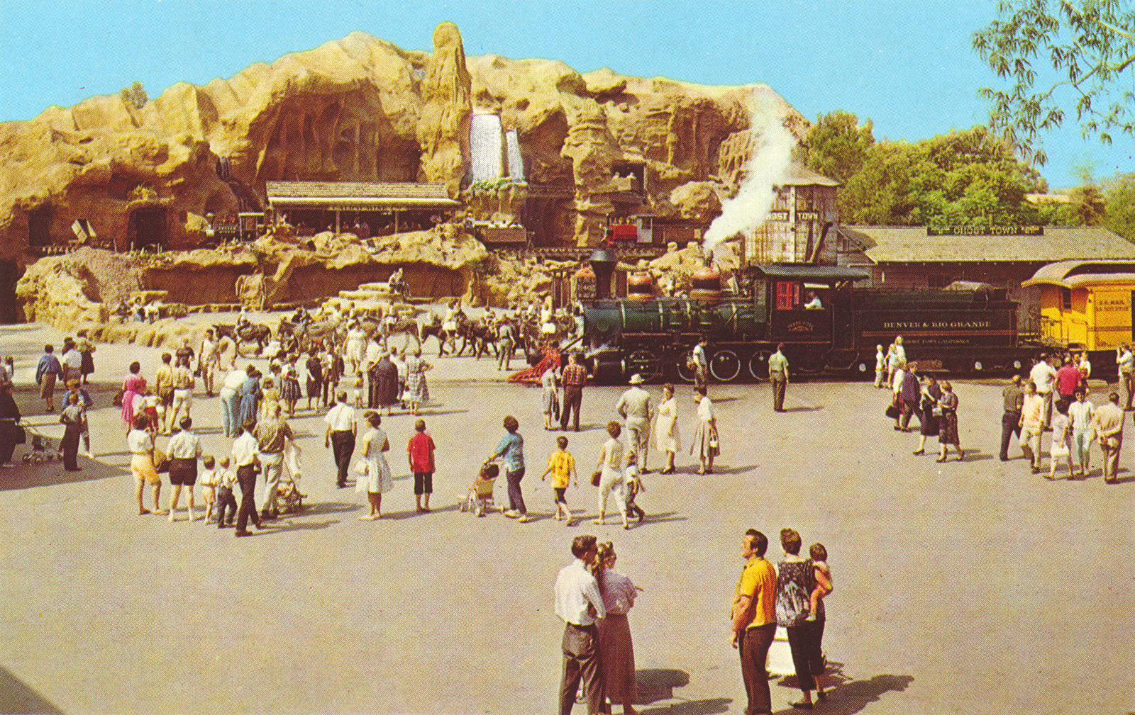 The Mine Train. A mountain stands with a small mine train that Guests board to see the mine within.