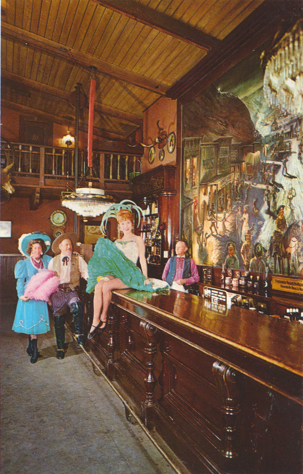 Inside the Calico Saloon, can-can girls sit on the bar.
