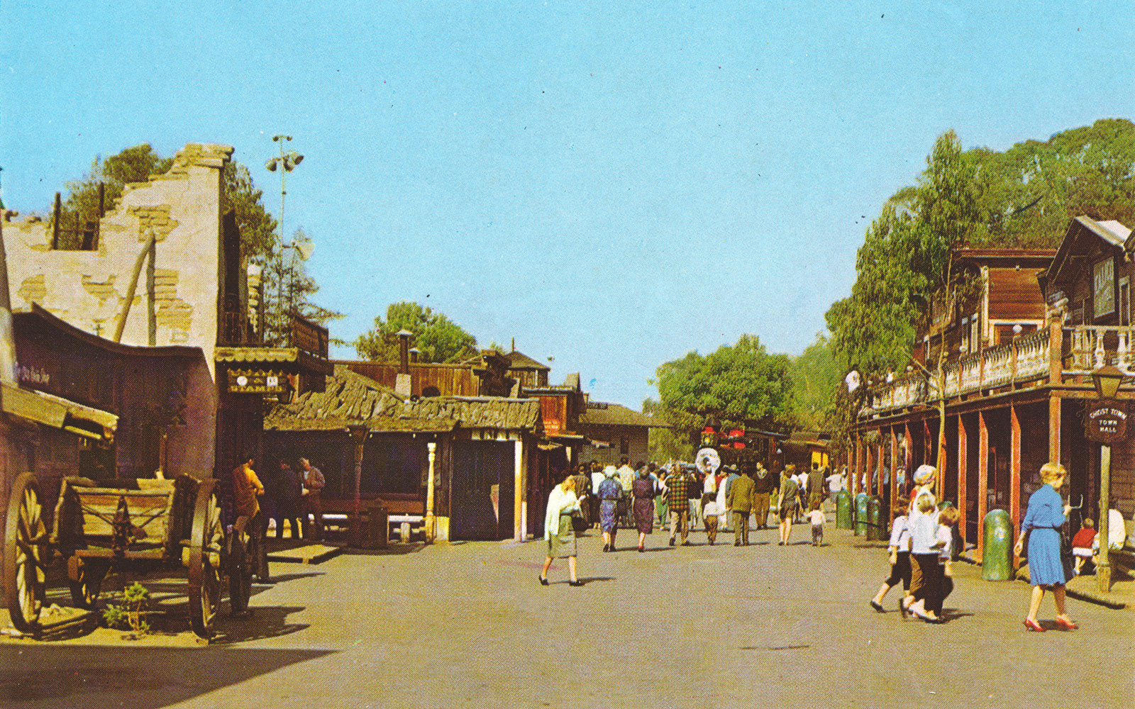 A look down one of the roads of Ghost Town with old western wooden buildings.