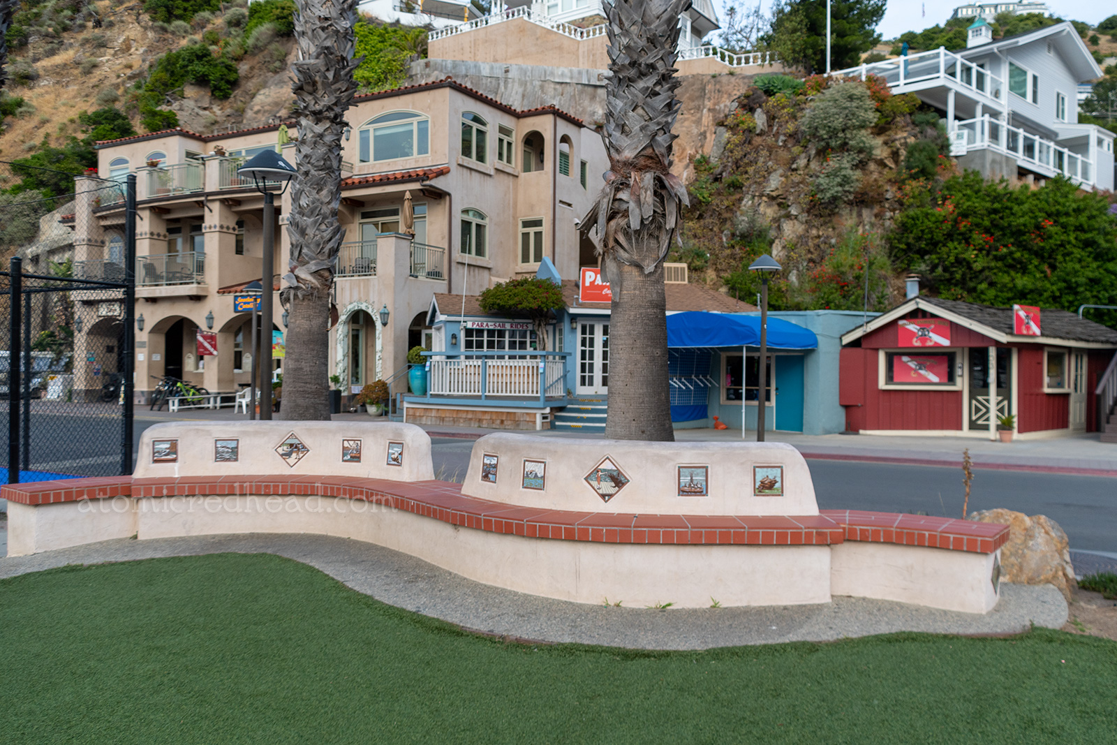 Colorful tiles featuring images of sea lions are set into an adobe walled bench.
