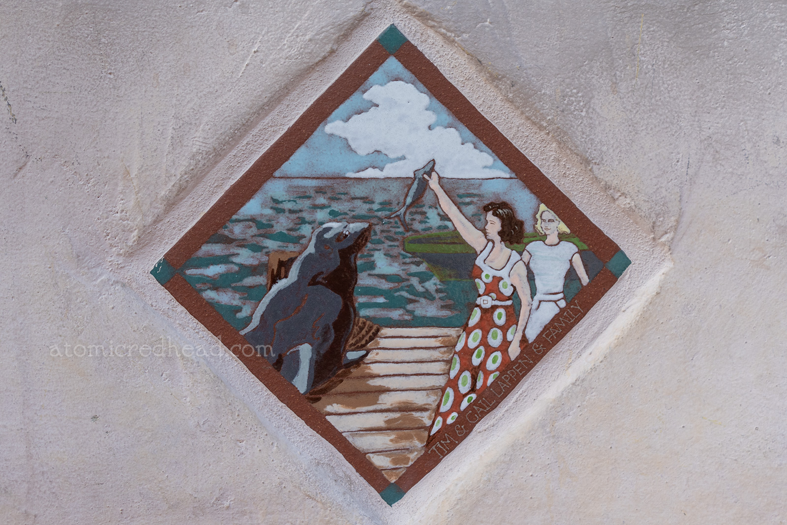 Close up of a tile of two woman feeding Old Ben.