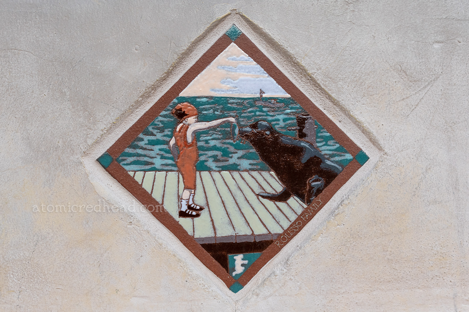 Close up of a tile version of the infamous postcard of Bernice Cameron feeding Old Ben.