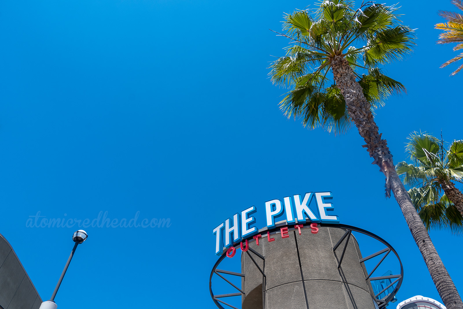 A circular tower with letters reading "The Pike Outlets"
