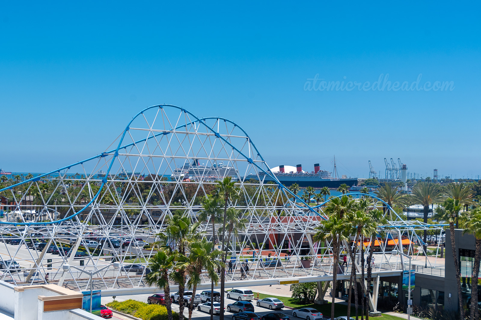 A view of the Cyclone Racer Bridge with the Queen Mary behind it.