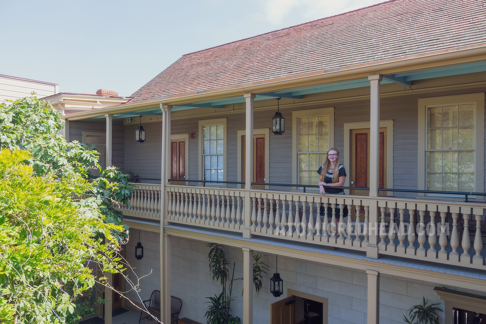 Myself standing on the upper balcony, wearing a black dress with silver trim.