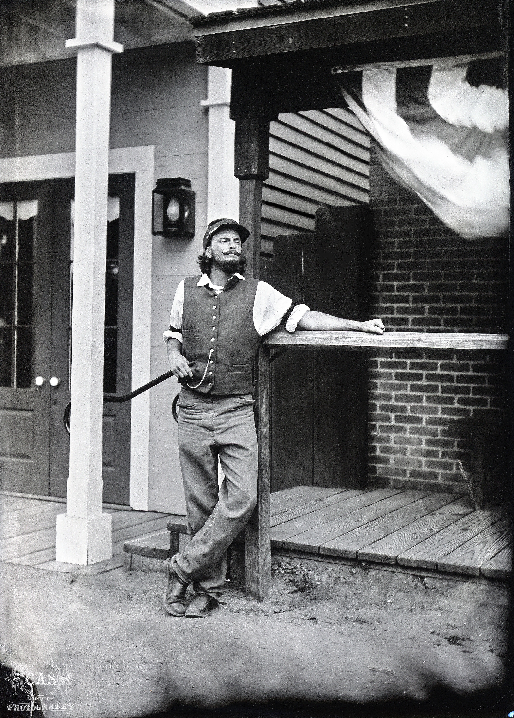 One of Catherine's subjects, a man in period clothing leaning against a post.