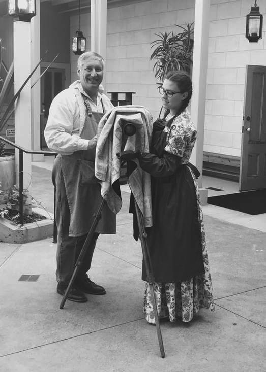 A black and white image of Catherine and her father with their camera.